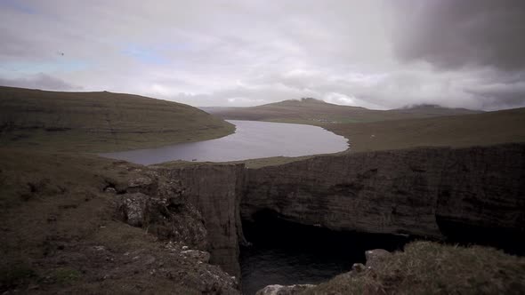 Sorvagsvatn Lake Over the Cliffs in Vagar Island Establishing Shot, Sliding Camera