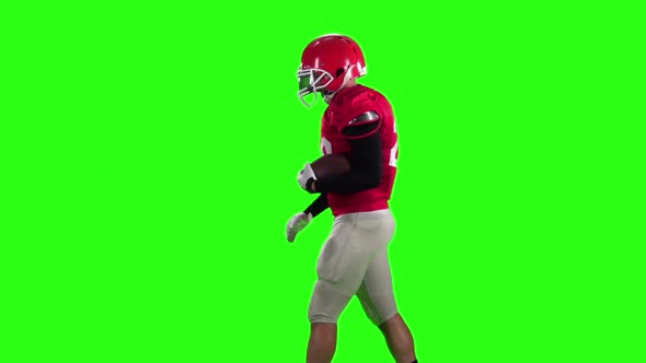 Football Player in a Red Helmet Comes with a Ball. Slow Motion, Green Screen,
