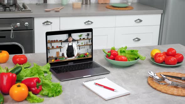 Laptop Computer with Man Chef Food Blogger in Screen Tells Teaches Student