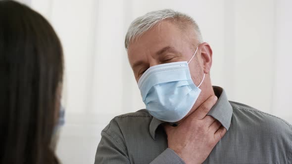 Mature Man Having Sore Throat Talking With Female Doctor Indoor