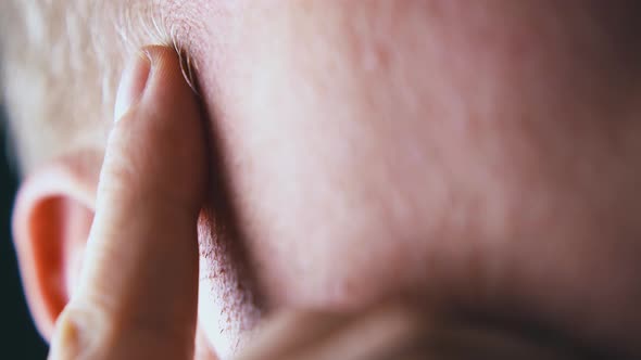 Man Puts and Raises Index Finger on Temple Near Grey Hair