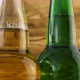 Two beer bottles rotating on wood texture surface - VideoHive Item for Sale