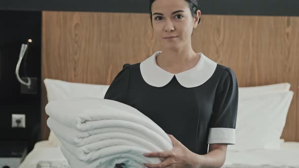 Housekeeper with Towels in Hotel Room