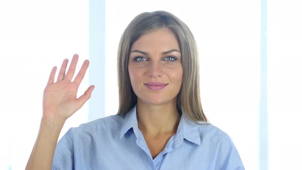 Portrait of Beautiful Young Woman Waving Hand to Welcome