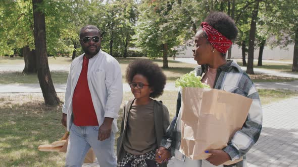 African American Family Walking after Food Shopping