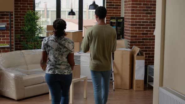 Husband and Wife Moving in New Home with Carton Boxes