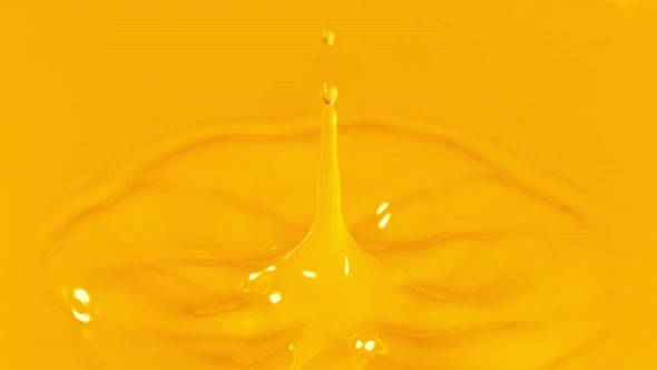 Super Slow Motion Detail Shot of Orange Juice Liquid Drop at 1000 Fps