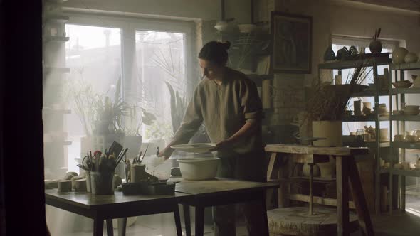 Young Woman Is Glazing Big Plate