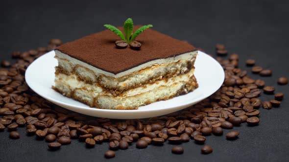 Portion of Traditional Italian Tiramisu dessert and coffee beans