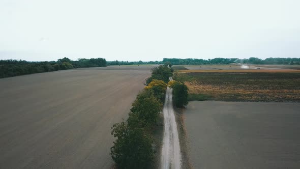 Drone shot over the field road during harvest