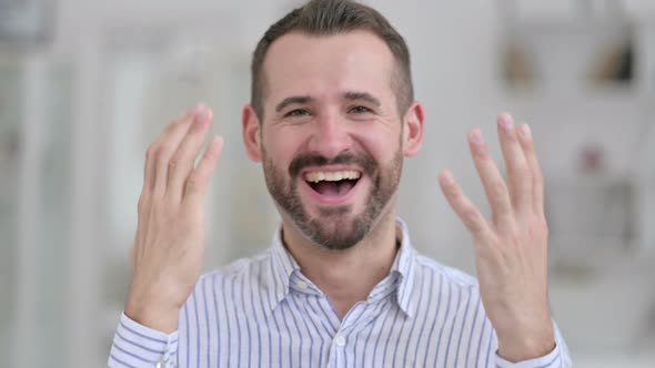 Portrait of Ambitious Young Man Celebrating Success