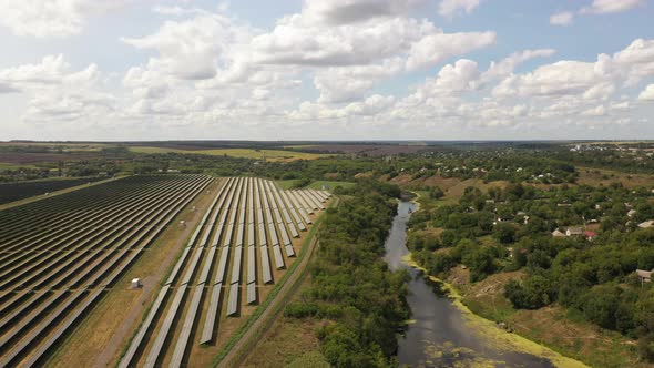 Aerial view of the Solar panels on a hill above the river