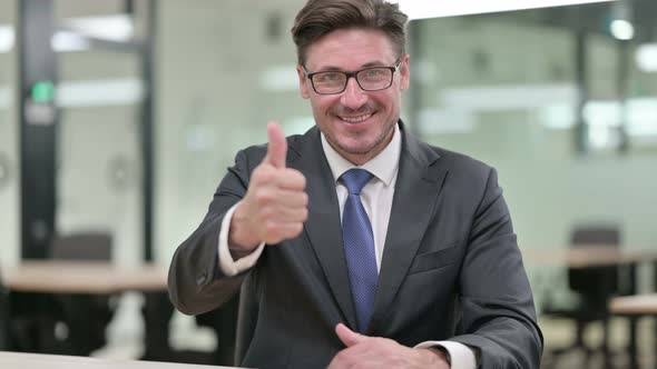 Positive Middle Aged Businessman Doing Thumbs Up 