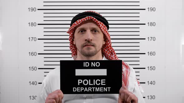 Mugshot of an Arab Wearing Glasses at the Police Station