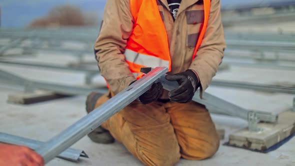 Worker installs solar panels. Man installing alternative energy photovoltaic solar panels