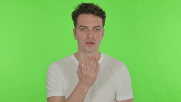 Flying Kiss By Young Man on Green Background