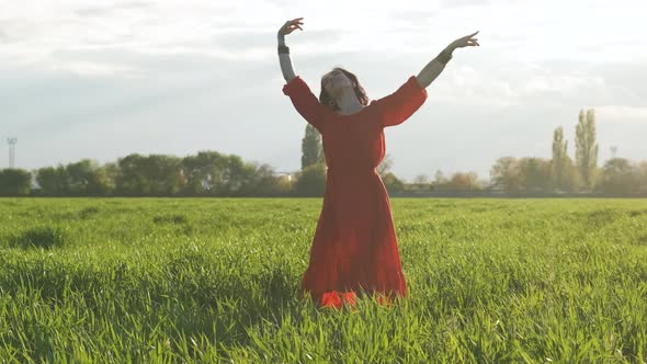 Beautiful Spanish Brunette Woman in Red Dress Dancing at Sunset in Wheat Field Slow Motion Shot