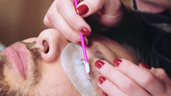Beautician is Covering Eyelashes of Male Client by Keratin Composition