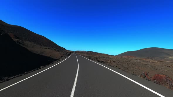 Travel and drive concept day. Long straight asphalt road with nature in background and blue sky.