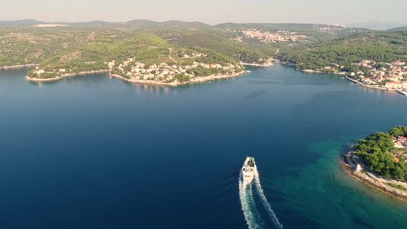 Aerial view of ferry boat approaching Sumartin port, Brac island, Croatia.