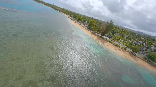 Extreme racing drone flight over playa Punta Popy at Las Terrenas in Dominican Republic. Aerial forw