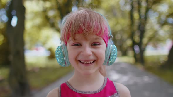 Portrait of Athletic Sport Runner Child Girl Training Listening Favorite Music Song in Headphones