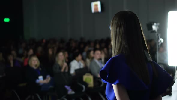 Female Speaker Giving Presentation in Lecture Hall