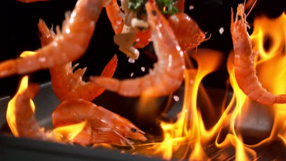 Super Slowmotion Footage of Throwing Fresh Prawns and Seasoning on Ignited Pan 1000Fps