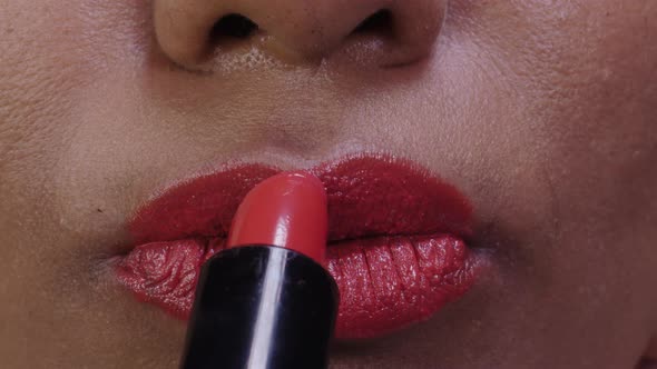 Applying Red Lipstick