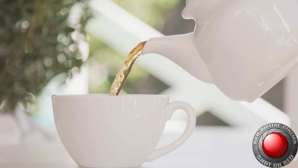 Tea Pouring Into A White Cup From A Pot Outside On A Patio Shot On Red Camera