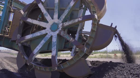 The big stacker machine loads the coal onto the conveyor belt.