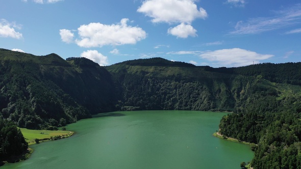 Volcanic crater with blue lake inside. Aerial drone top down flight over, Azores, 4k.