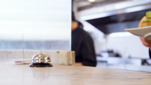 Waitress serving food at counter 4k