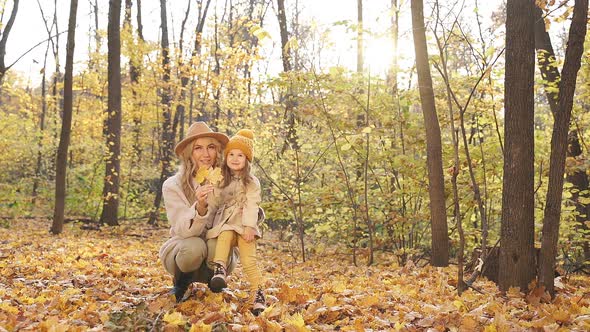 Lovely Mother with Kids in Autumn Nature