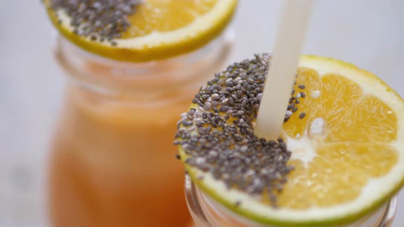 Close Up of Healthy Vegan Fresh Juices Full of Vitamins Decorated with Orange Slices Chia Seeds and