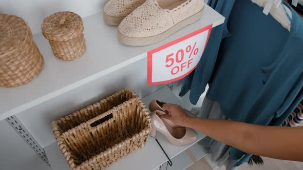 Woman Grabbing Last Pair of Shoes in Store