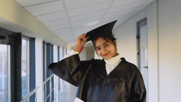 Indian Female Graduate in Black Gown and Wearing Master's Hat in University