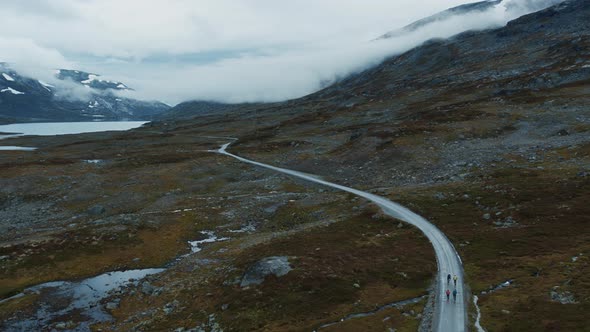 Flying Drone Shot of Cyclists Group in Mountains