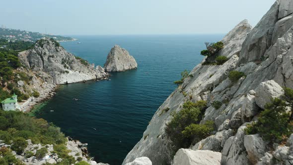 Aerial Fly Behind Rock Krylo Lebedya  Swan Wing with Diva Rock and Black Sea in Background