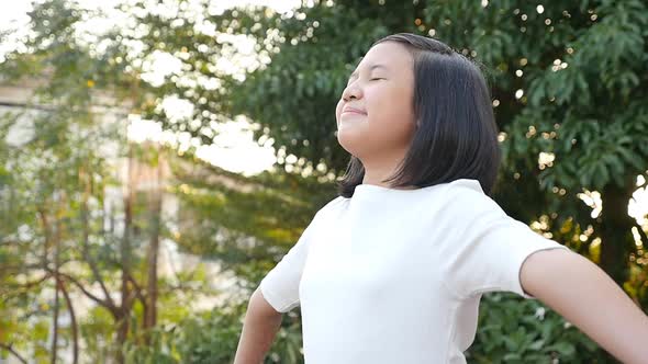 Portrait Of Beautiful Asian Girl With Closed Eyes Under The Rain