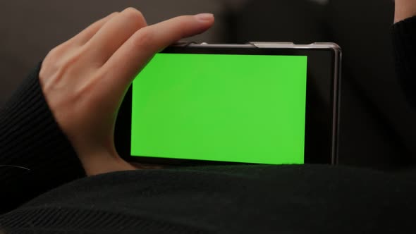 Green screen on smart phone while scrolling through pages 4K 2160p UHD footage - Looking to cell pho