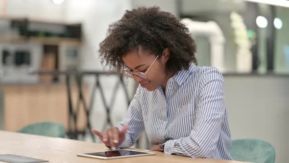 Young African Businesswoman Using Tablet in Office