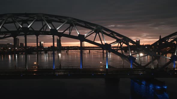 Train Bridge Over River Daugava in Riga Latvia During Midnight Sunset