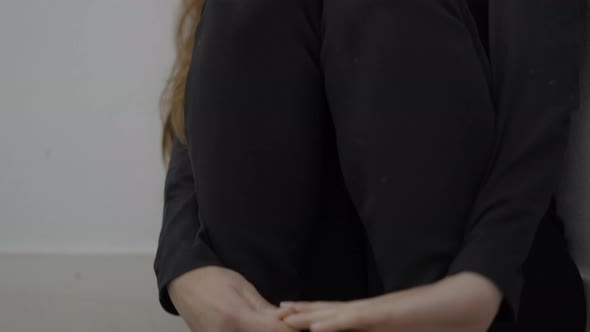 Closeup of Young Frightened Woman Sitting in Corner of Room Tilt Up