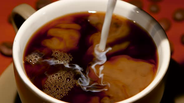 In Cup with Hot Black Coffee Added Many Milk. Closeup