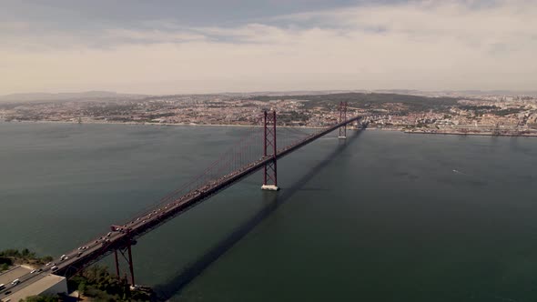 Busy two ways traffics on Ponte 25 de Abril bridge connecting Lisbon and Almada over Tagus river.