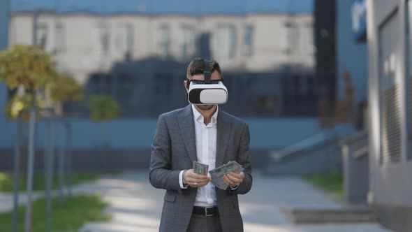 Rich Man Wearing VR Headset Counting Money