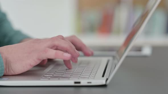 Close Up of Hands of Man Typing on Laptop