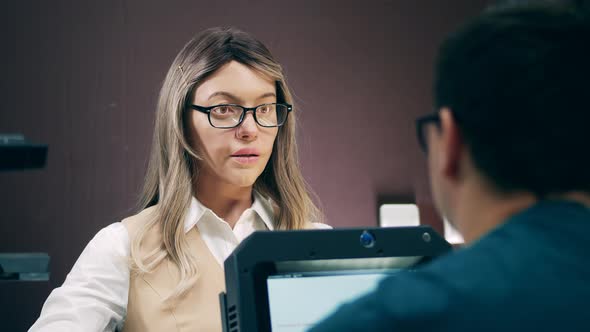 Female Humanlike Droid Is Talking To a Client