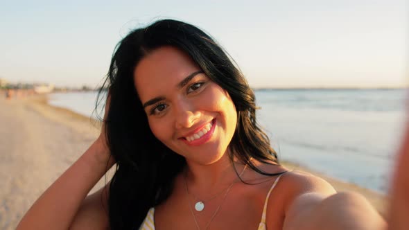 Smiling Woman in Bikini Taking Selfie on Beach